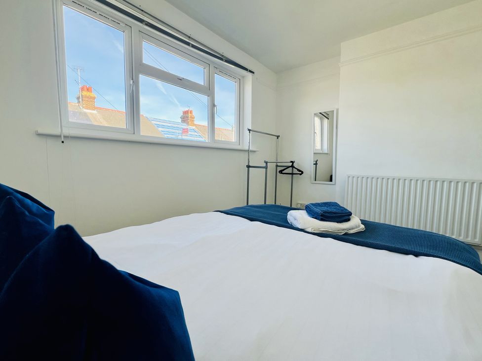 A bedroom with a bed and window at 11 Langer Road Felixstowe