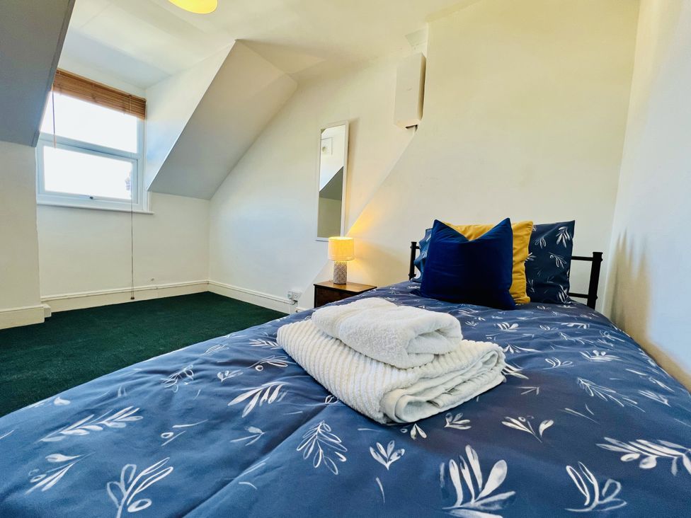 A bedroom with a bed and bedside lamp at 11 Langer Road in Felixstowe