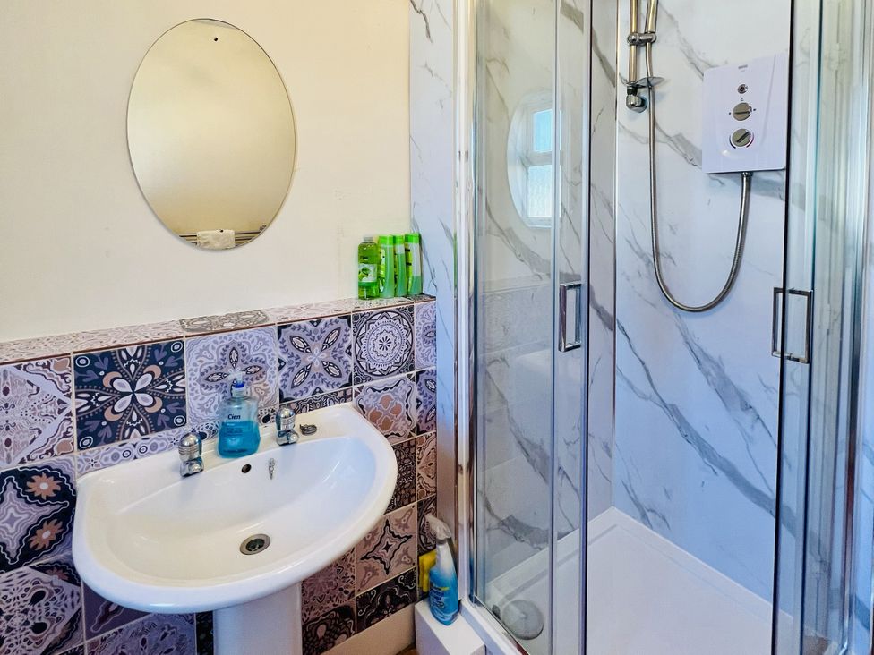 A bathroom with a sink and shower at 11 Langer Road in Felixstowe