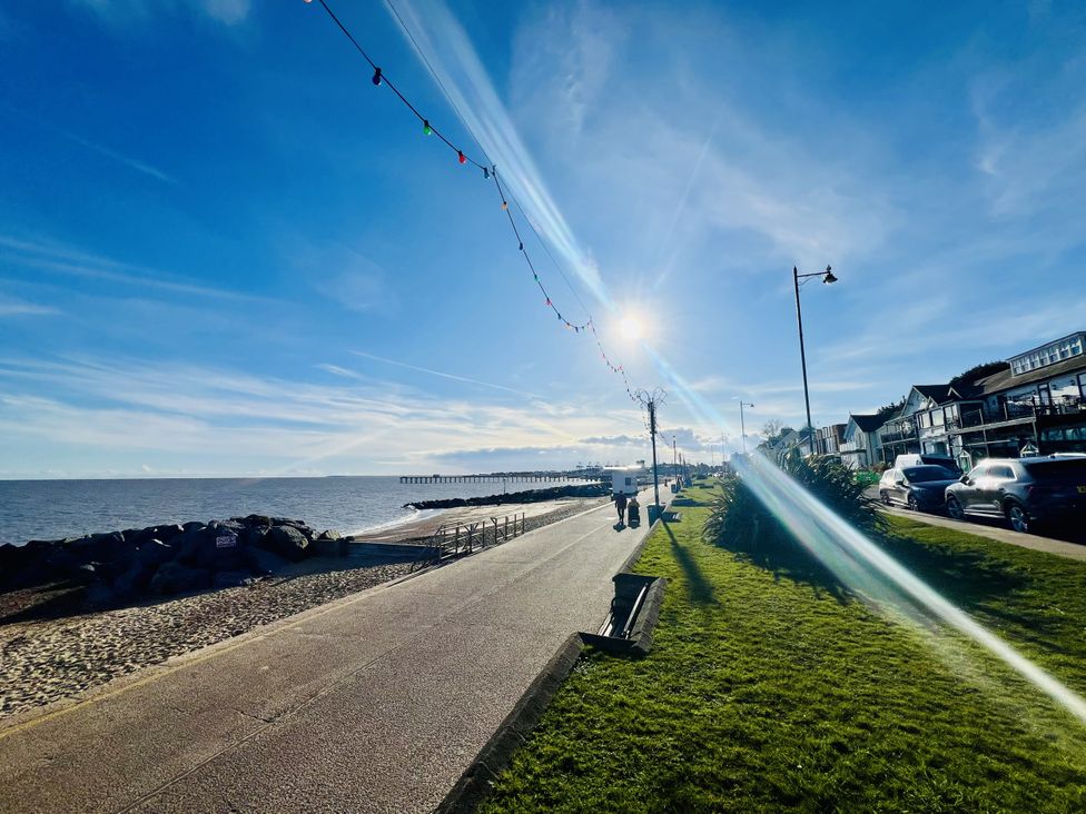 A coastal scene with a pathway beside the sea at 11 Langer Road in Felixstowe