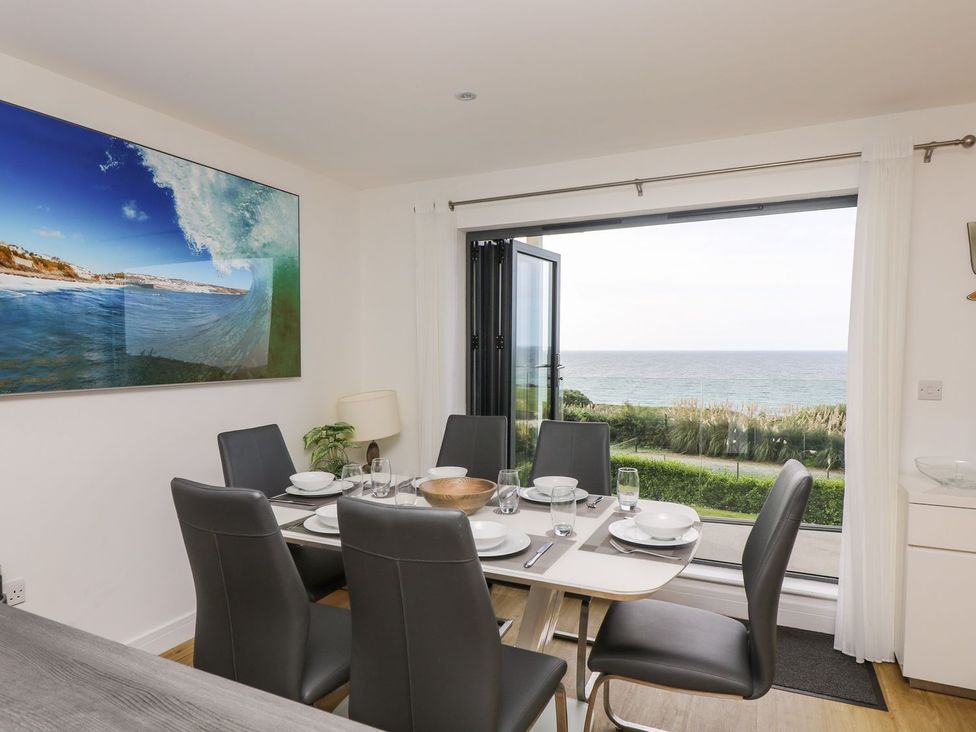 A dining room with a sea view at Praa Waves in Penzance