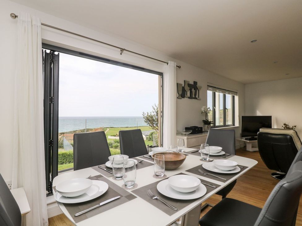 A dining room with a view of the sea at Praa Waves in Penzance