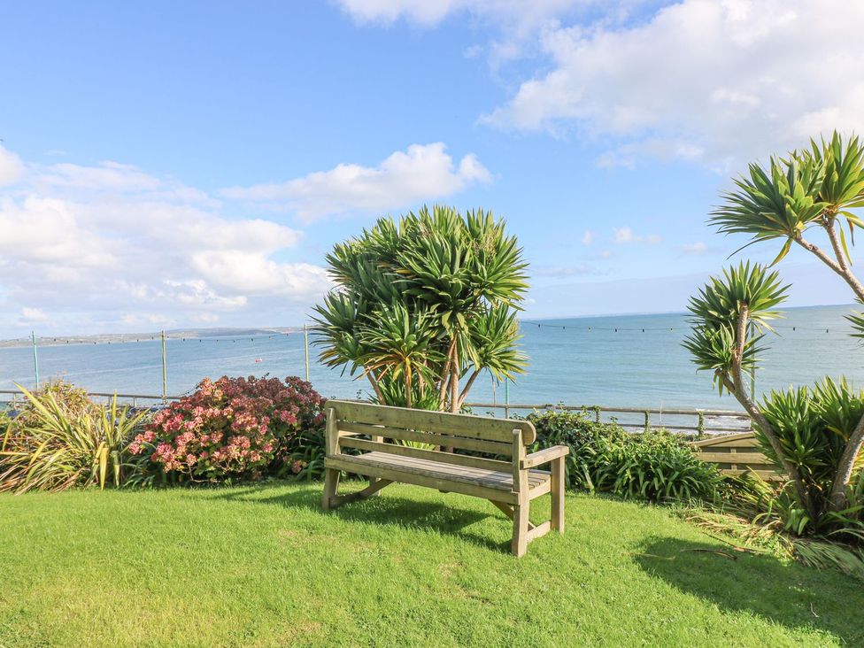 A bench overlooking the ocean at Harbour Lights in Penzance