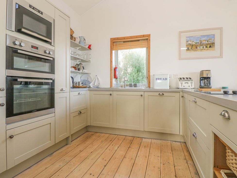 A kitchen with appliances and cabinets at Harbour Lights in Penzance