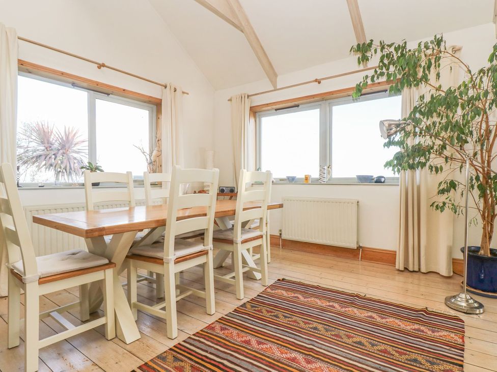 A dining room with a table and chairs at Harbour Lights in Penzance