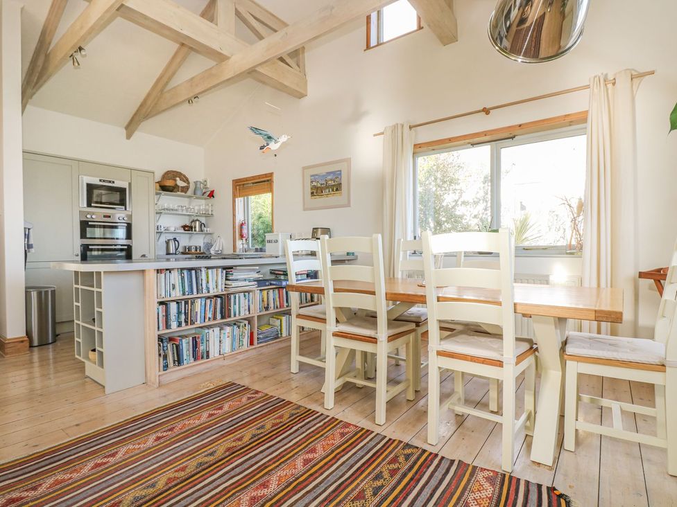 A kitchen with a table and chairs at Harbour Lights in Penzance