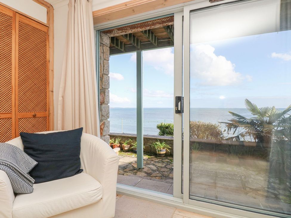A living room with a sofa and a view of the sea at Harbour Lights in Penzance