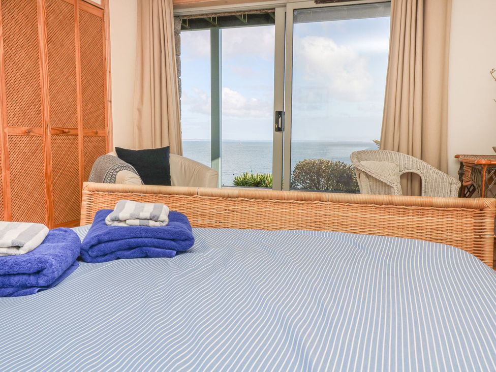 A bedroom with a view of the sea at Harbour Lights in Penzance