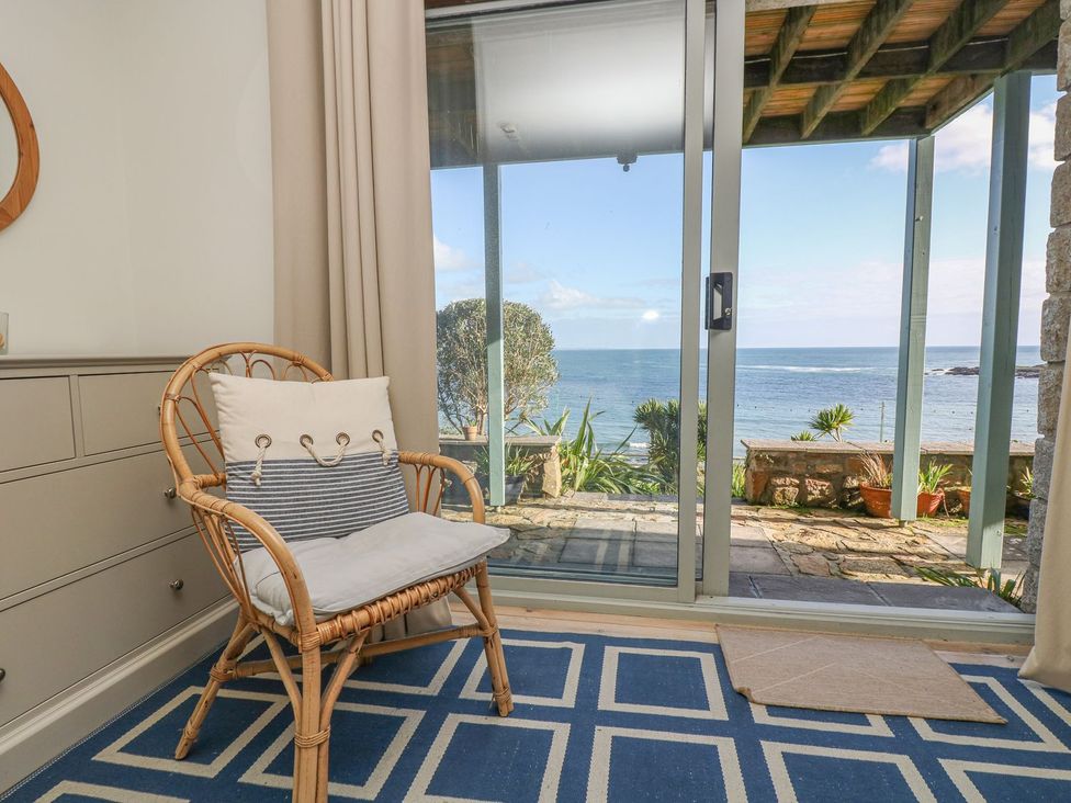 A living room with a view of the ocean at Harbour Lights in Penzance