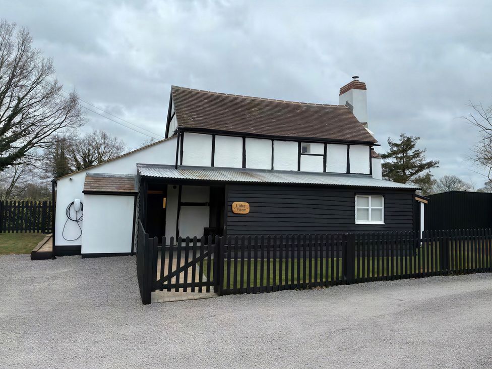 A house with a fenced driveway at Lake Farm in Gloucester