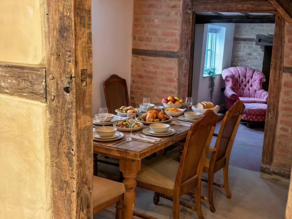 A dining room with a table set for a meal at Lake Farm in Gloucester