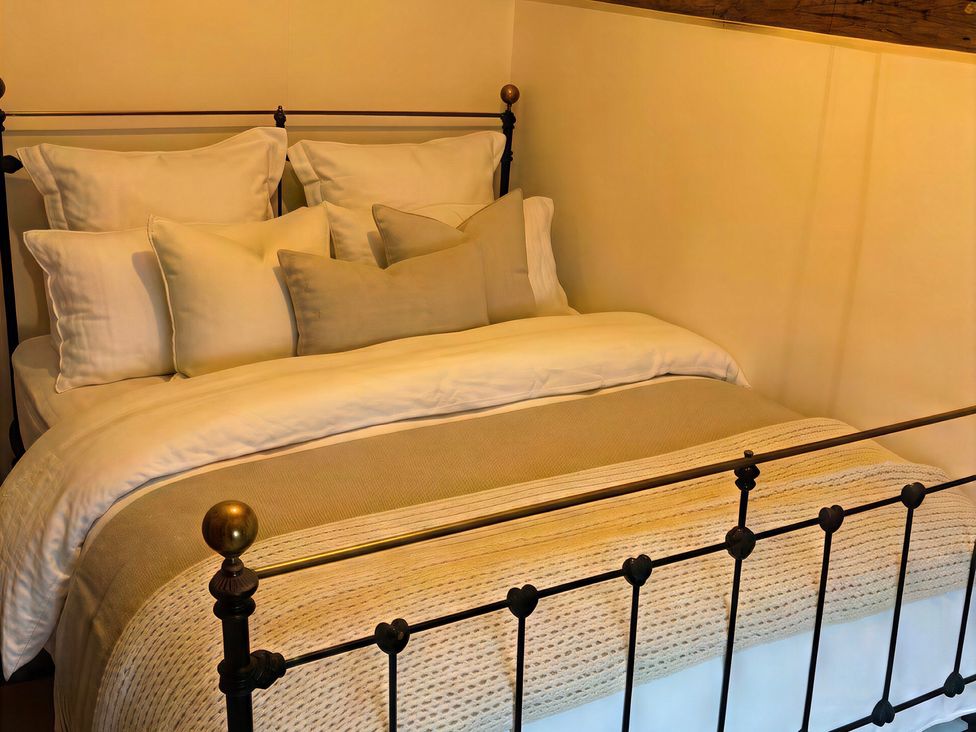 A bed with pillows and bedding at Lake Farm in Gloucester