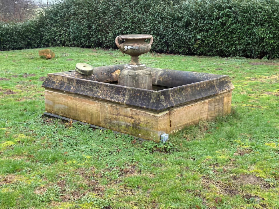 An ornamental fountain in a garden area at Lake Farm in Gloucester
