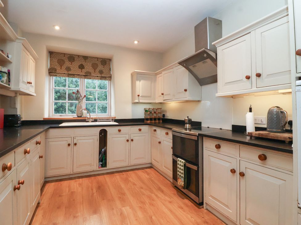 A kitchen with cabinets and an oven at Waterloo Mill Cottage Wotton-Under-Edge
