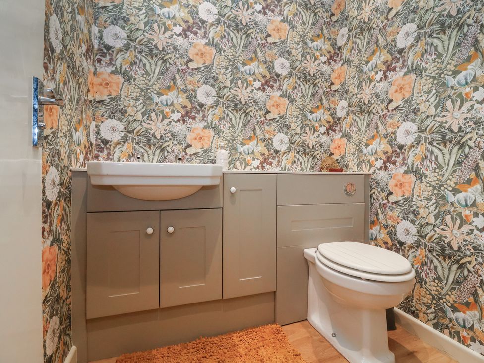 A bathroom with a sink and toilet at Waterloo Mill Cottage in Wotton-Under-Edge