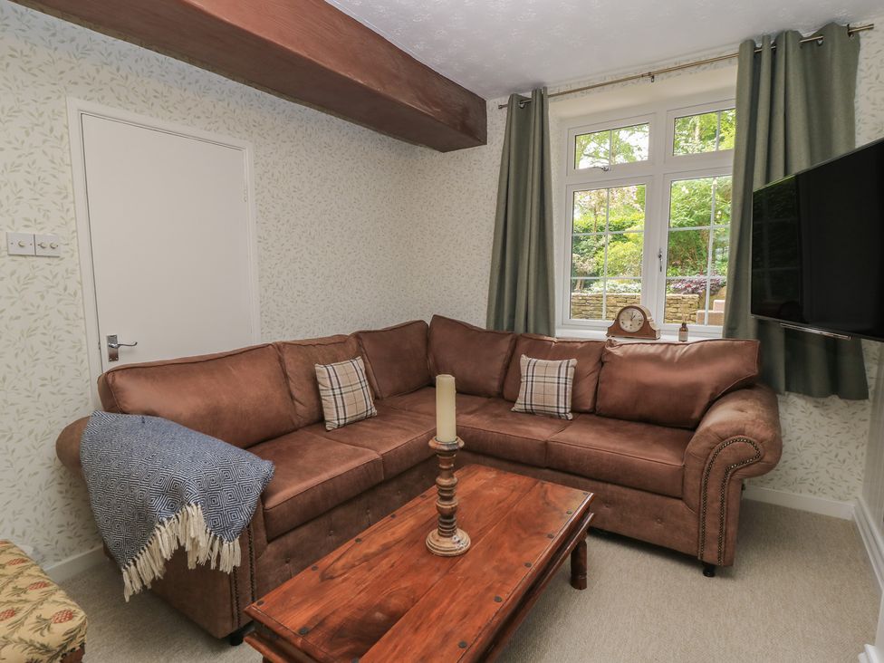 A living room with a sofa and coffee table at Waterloo Mill Cottage in Wotton-Under-Edge