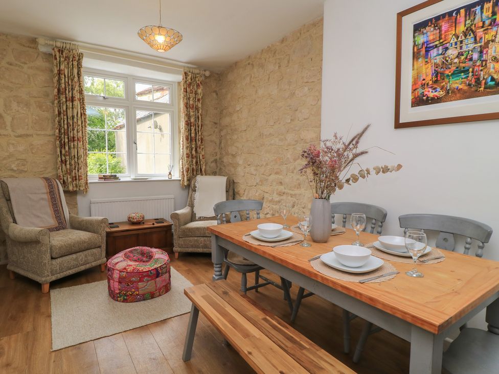 A dining room with table and chairs at Waterloo Mill Cottage Wotton-Under-Edge