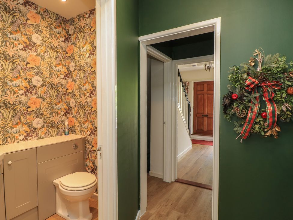 A bathroom with a toilet and vanity at Waterloo Mill Cottage in Wotton-Under-Edge
