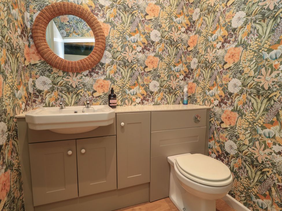 A bathroom with a wash basin and toilet at Waterloo Mill Cottage in Wotton-Under-Edge