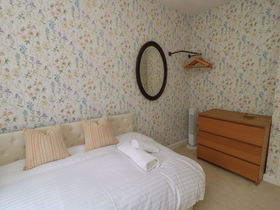 A bedroom with a bed and furniture at Waterloo Mill Cottage in Wotton-Under-Edge