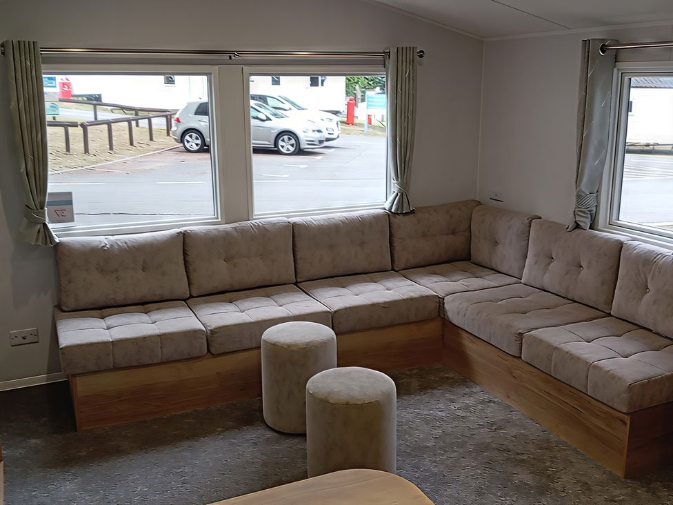 A living room with a sofa and round table at Caravan Thorness Bay Holiday Park Thorness Lane