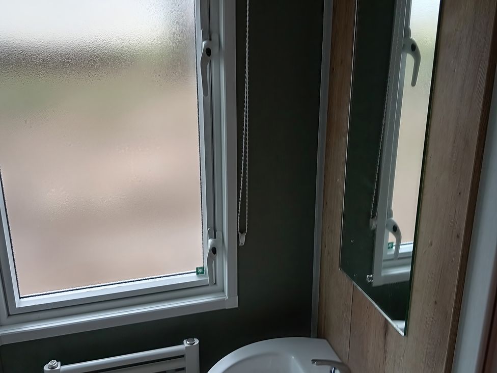 A bathroom with a toilet and mirror at Caravan Thorness Bay Holiday Park Thorness Lane
