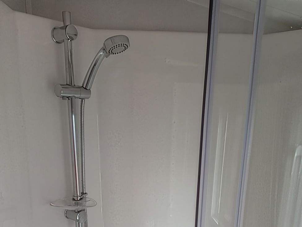 A shower with a silver shower head and control in a bathroom at Caravan Thorness Bay Holiday Park Thorness Lane