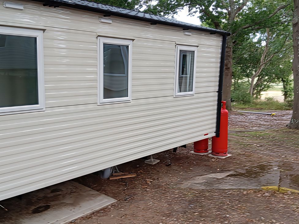 A caravan with gas canisters beside it at Caravan Thorness Bay Holiday Park Thorness Lane