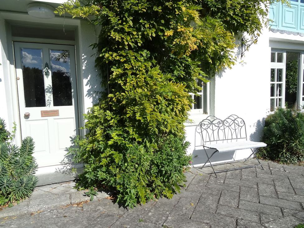An outdoor area with a door, bench, and plants at Mount Pleasant in Padstow
