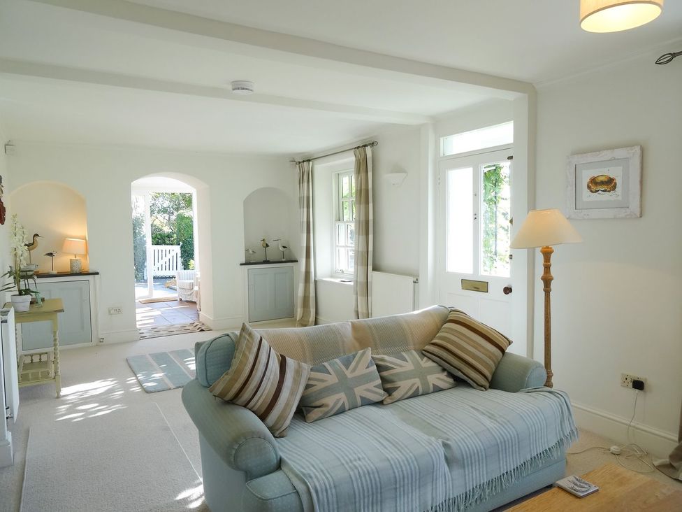 A living room with a sofa and lamp at Mount Pleasant in Padstow