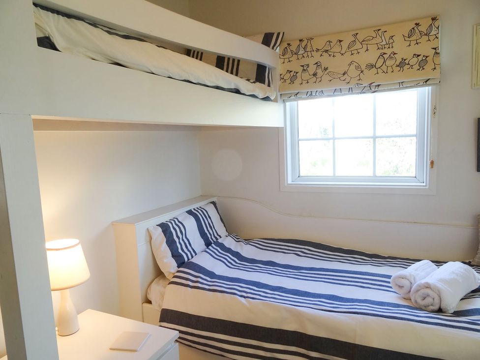 A bedroom with a bunk bed and single bed at Mount Pleasant in Padstow