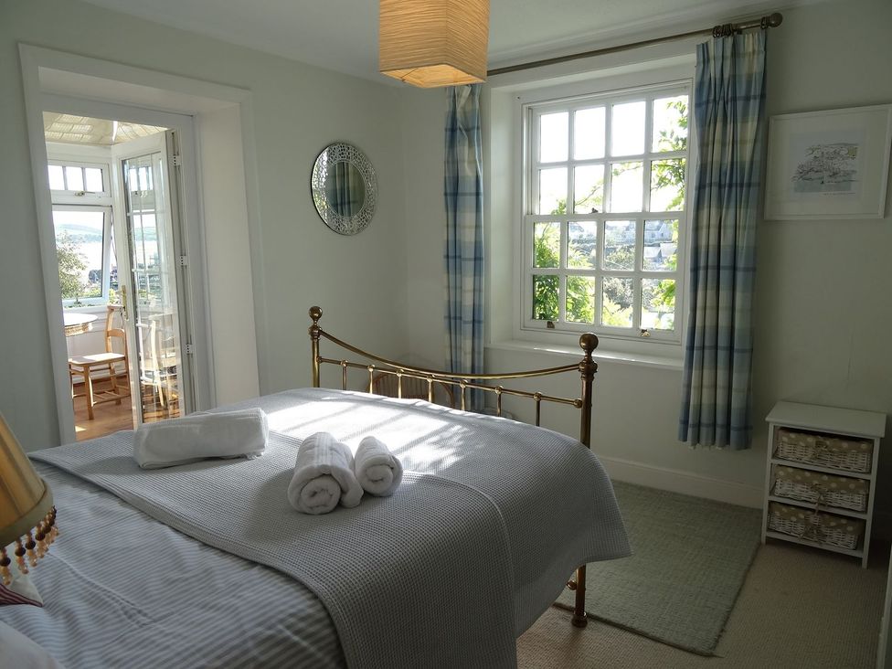 A bedroom with a bed and towels on it at Mount Pleasant in Padstow