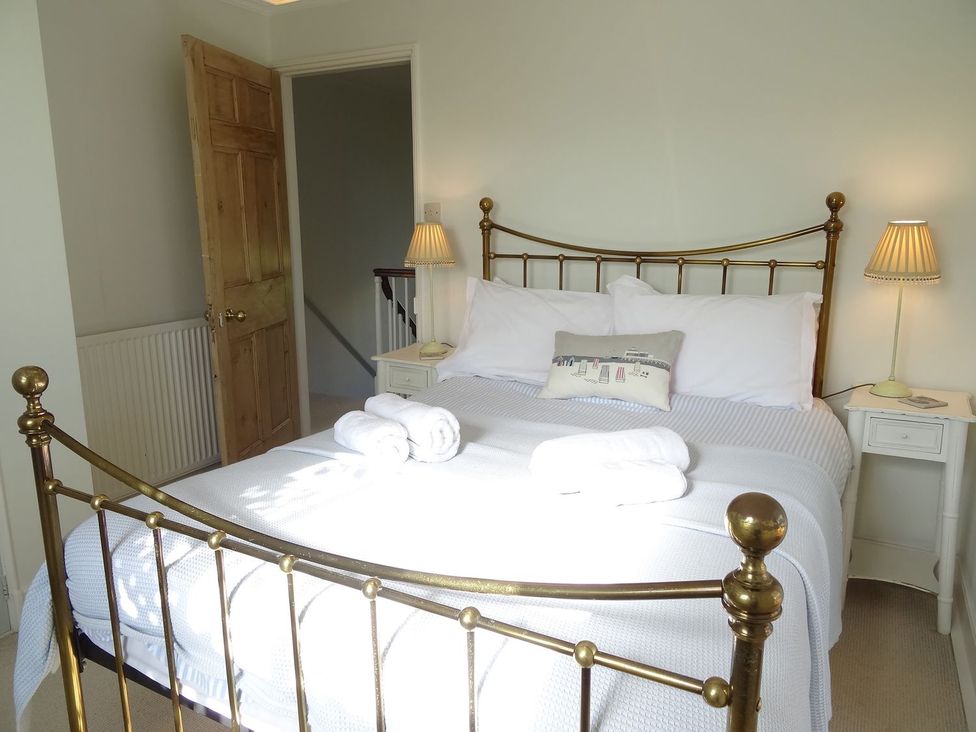 A bedroom with a bed and nightstand at Mount Pleasant in Padstow