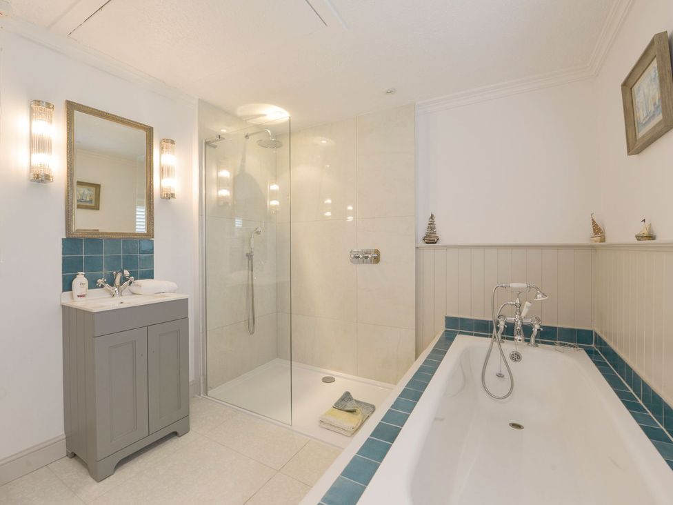 A bathroom with a bathtub and shower at Mount Pleasant in Padstow