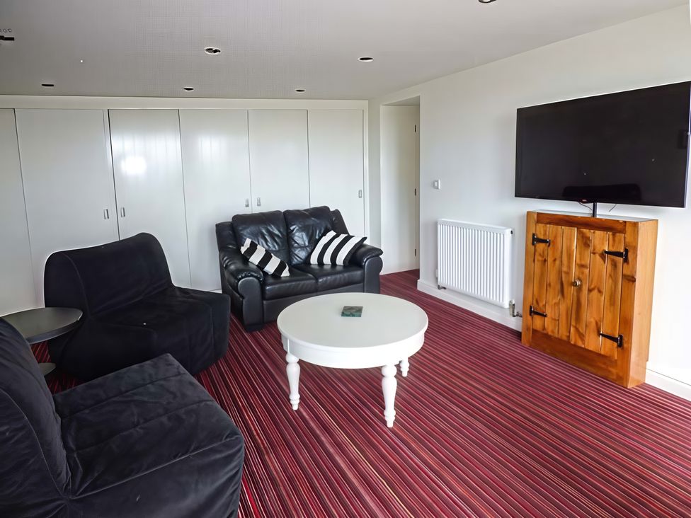A living room with a television and furniture at Beningborough