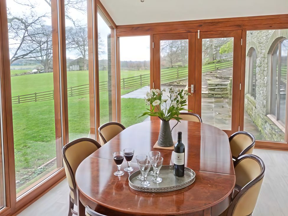 A dining room with a wooden table and wine at Beningborough