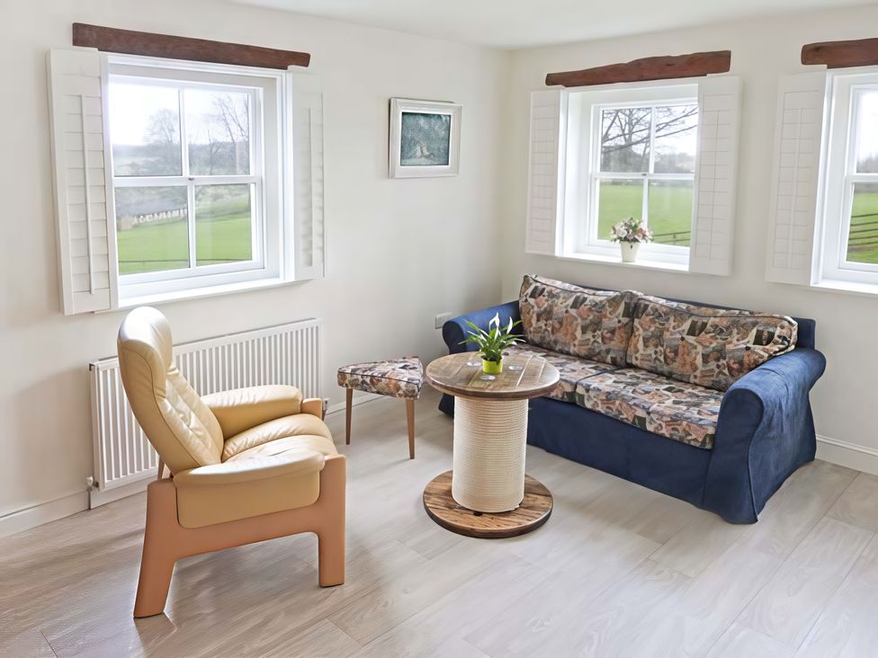 A living room with a sofa and armchair at Beningborough