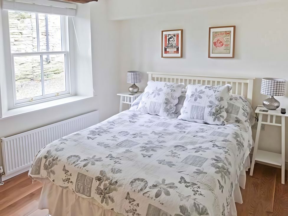 A bedroom with a bed and bedside tables at Beningborough