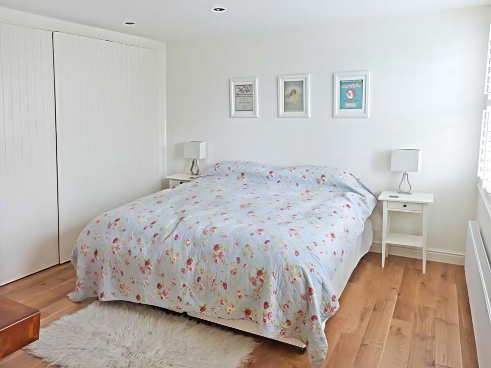A bedroom with a bed and nightstands at Beningborough