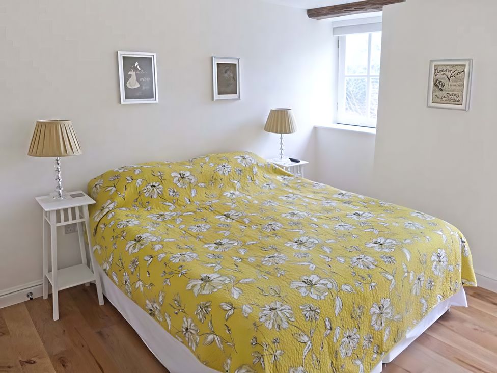 A bedroom with a bed and nightstands at Beningborough