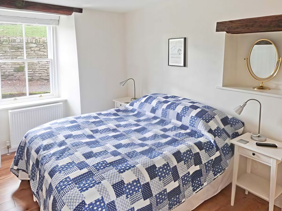 A bedroom with a bed and lamp at Beningborough