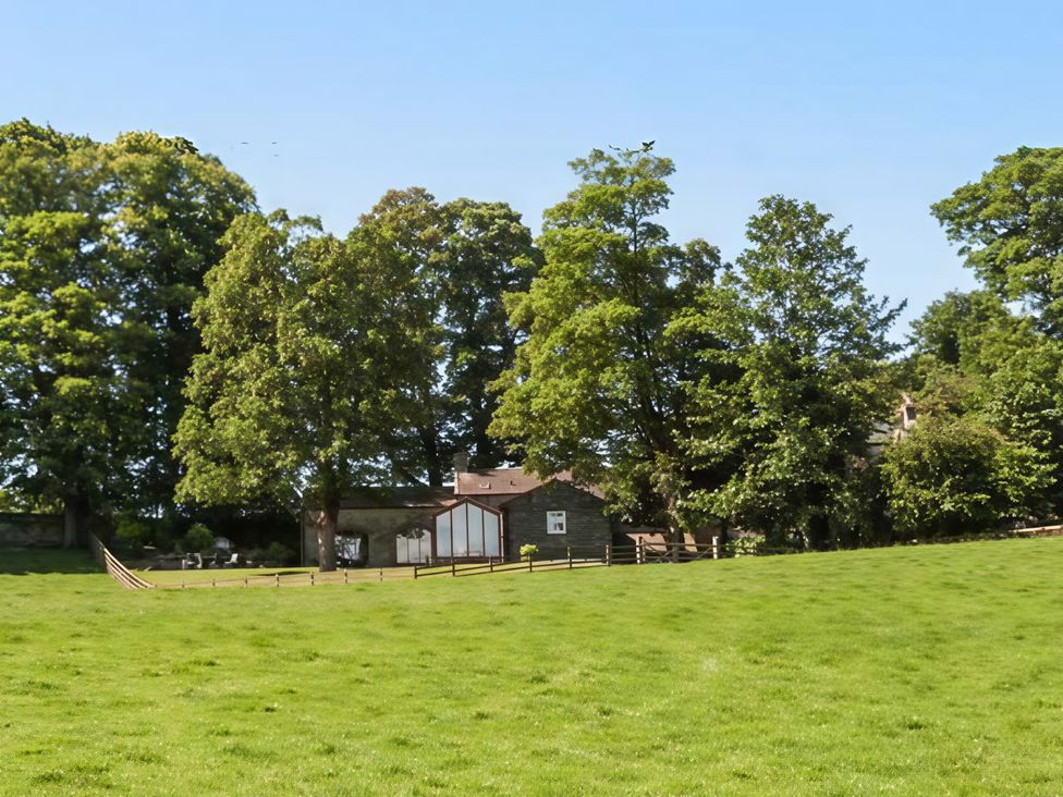 A field with trees and buildings at Beningborough