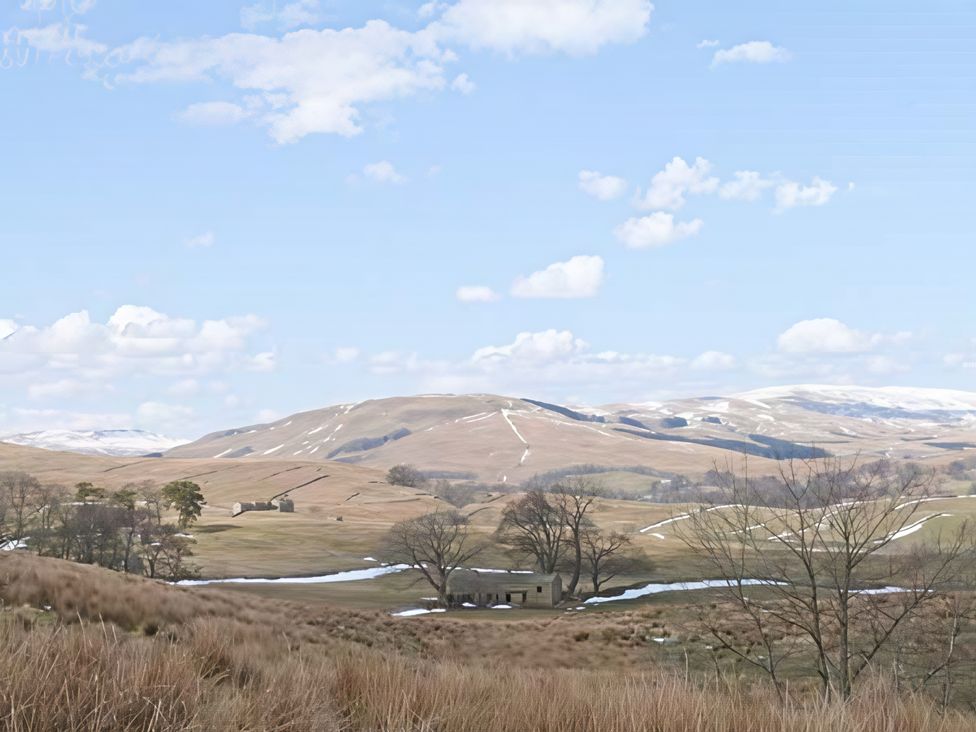 A landscape featuring hills, trees, a stream, and a building at Beningborough