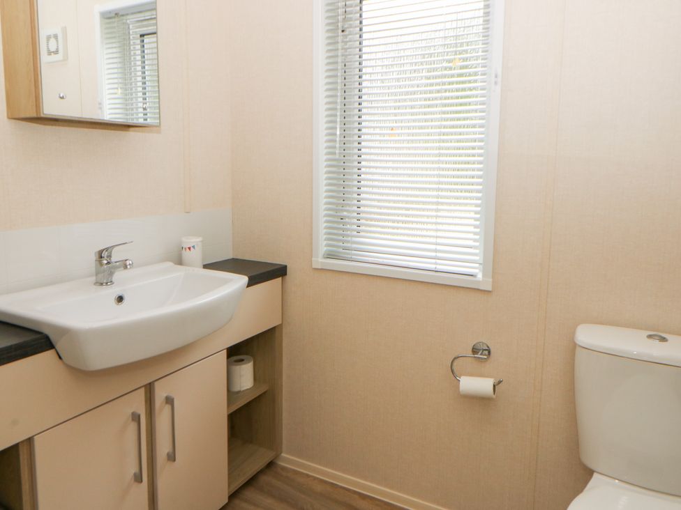 A bathroom with a sink and toilet at Beechwood Lodge