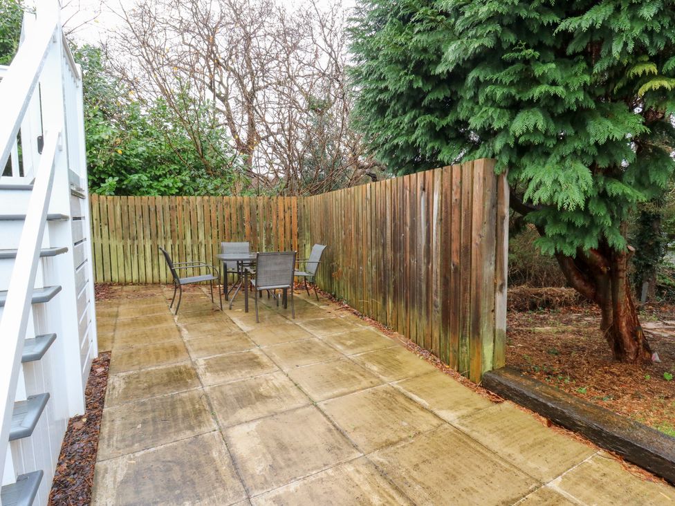 An outdoor seating area with a table and chairs at Beechwood Lodge