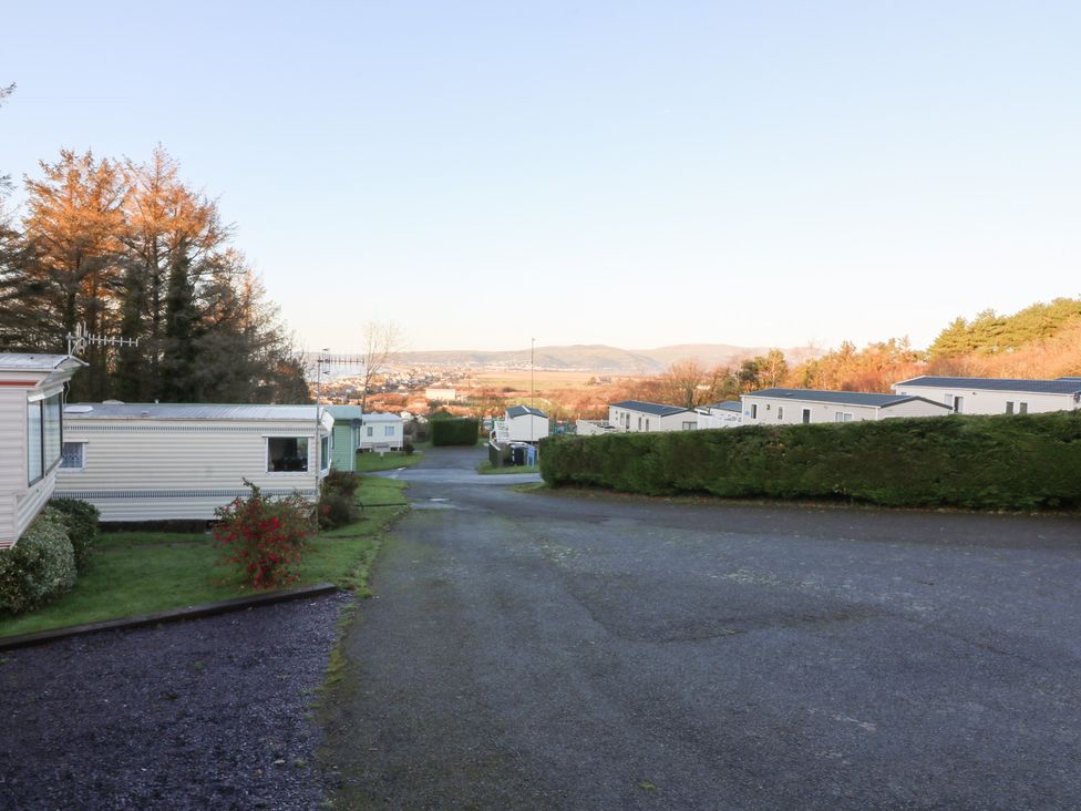 A view of caravans along a road with trees and hills at Beechwood Lodge in 