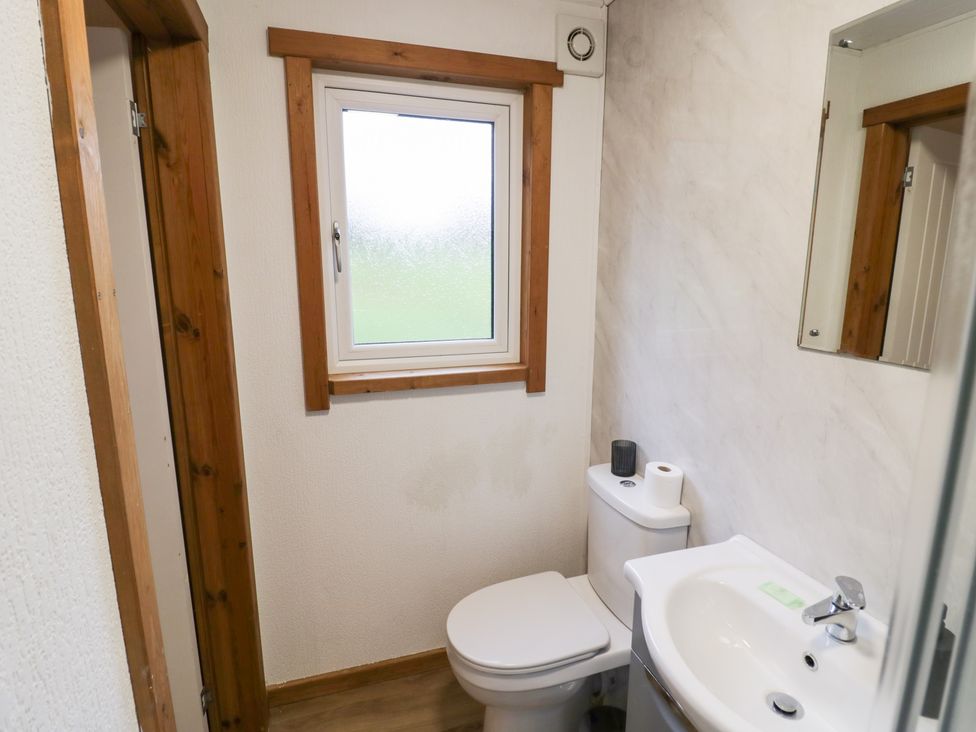 A bathroom with a toilet and sink at Elm Lodge in Rugeley