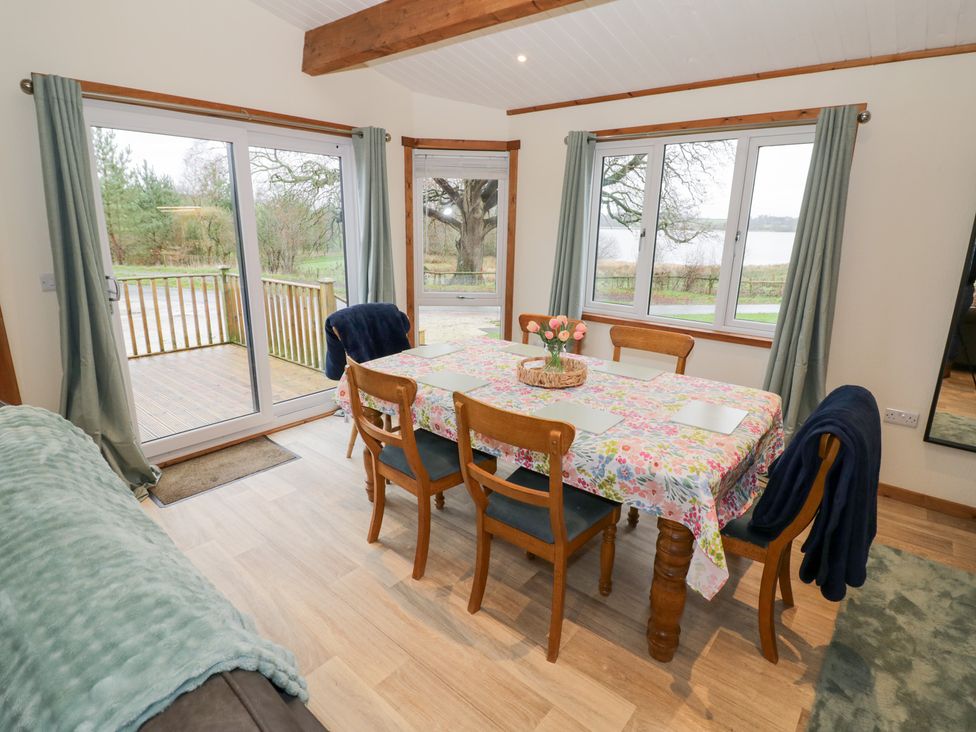 A dining room with a table and chairs at Cedar Lodge in Rugeley