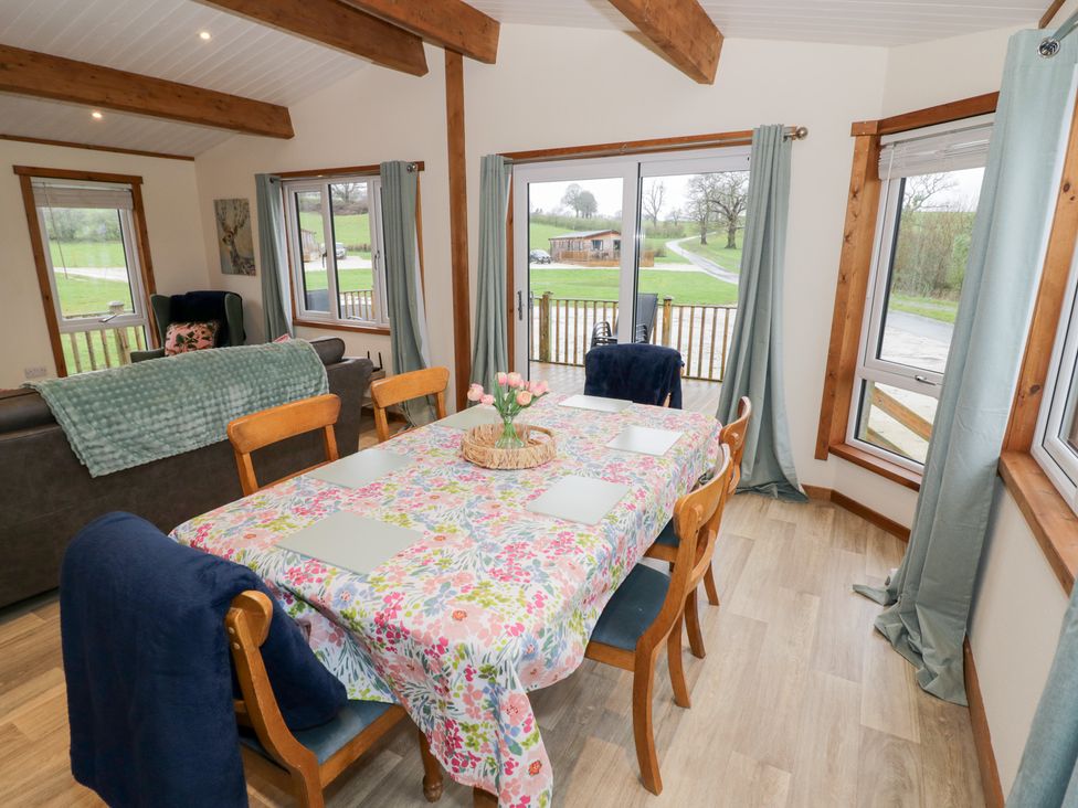 A dining room with a table and chairs at Cedar Lodge in Rugeley