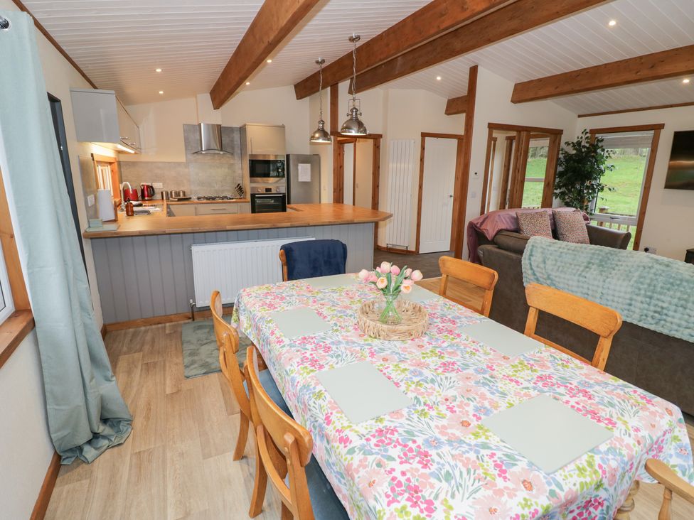 A dining room with a table and chairs at Cedar Lodge in Rugeley